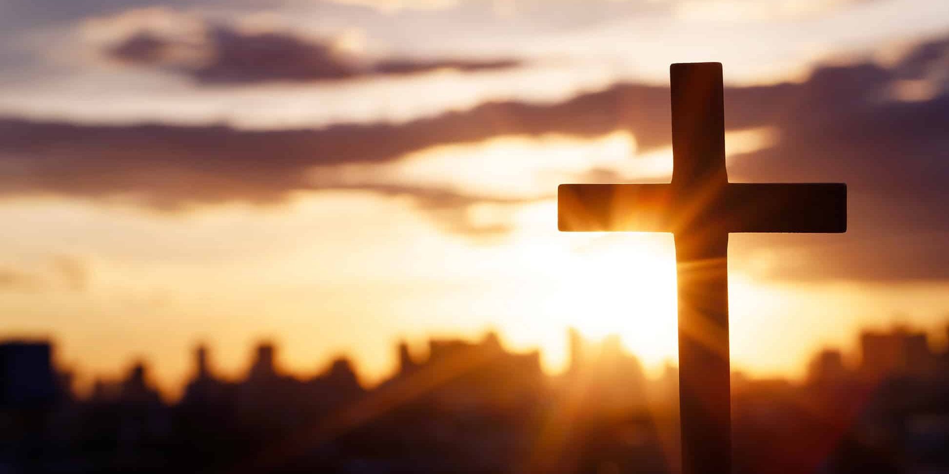 religious-cross-silhouette-at-sunset-with-city-2026-03-09-08-57-26-utc